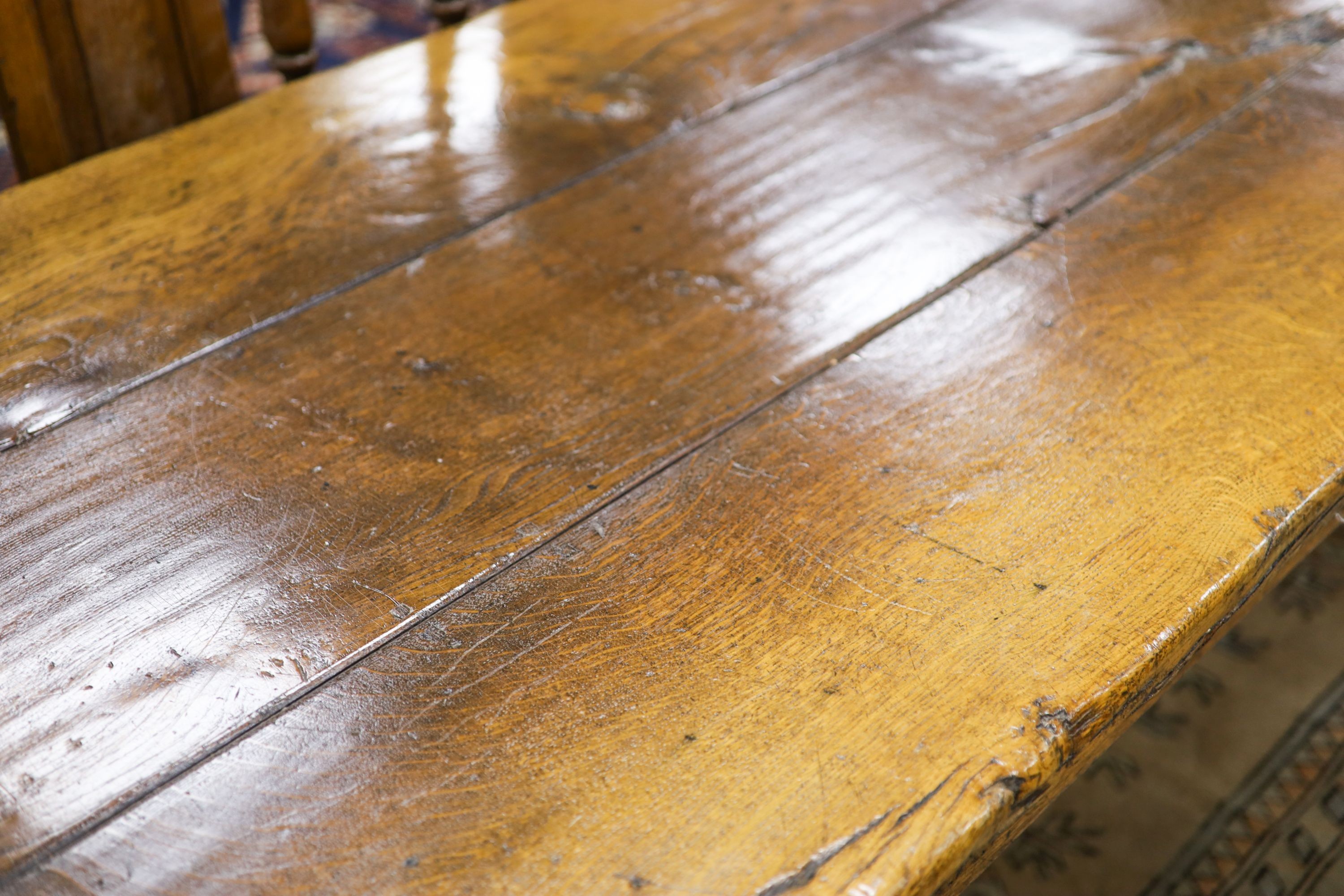 An 18th century style pale oak refectory dining table, length 305cm, depth 90cm, height 76cm